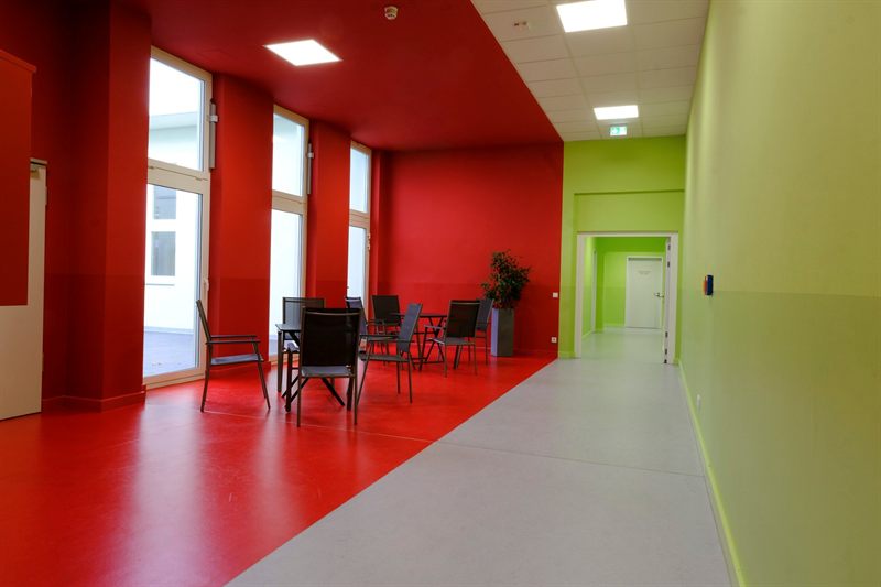 Foyer with seating in front of the windows to the atrium