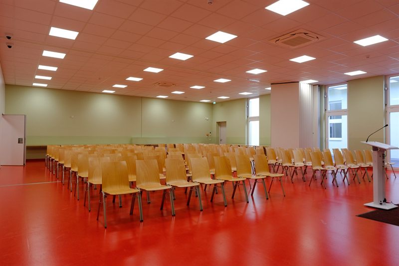 Assembly hall with rows of chairs and lectern